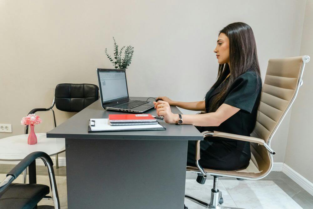 Professional small business owner working calmly at an organized desk.